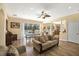 Open-concept living space showcasing wood floors, a modern ceiling fan, and a clear view of the dining area and pool at 21511 Wilderness Lake Blvd, Land O Lakes, FL 34637