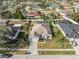 Aerial view of a single-Gathering home with a two-car garage, a well-manicured lawn, and mature landscaping at 22516 Magnolia Trace Blvd, Lutz, FL 33549