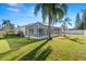 Spacious backyard featuring a screened-in pool area, lush green grass, and a privacy fence at 22516 Magnolia Trace Blvd, Lutz, FL 33549