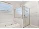 Bathroom boasts tub, glass enclosed shower and natural light at 22516 Magnolia Trace Blvd, Lutz, FL 33549