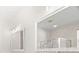 Bathroom features a vanity with mirror and shower over tub at 22516 Magnolia Trace Blvd, Lutz, FL 33549