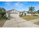 Charming one-story home with a well-manicured lawn, mature landscaping and a two-car garage at 22516 Magnolia Trace Blvd, Lutz, FL 33549