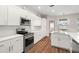 Bright kitchen featuring white cabinets, stainless steel appliances, and a large island with a sink at 22516 Magnolia Trace Blvd, Lutz, FL 33549