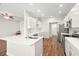 Modern kitchen featuring white cabinets, stainless steel appliances, and a large island with seating at 22516 Magnolia Trace Blvd, Lutz, FL 33549