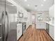 Modern kitchen featuring white cabinets, stainless steel appliances, and a large island with seating at 22516 Magnolia Trace Blvd, Lutz, FL 33549