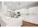 Bright modern kitchen featuring white cabinets, stainless steel appliances, and a large center island at 22516 Magnolia Trace Blvd, Lutz, FL 33549