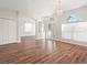 Bright living room with wood floors and a large window with vertical blinds at 22516 Magnolia Trace Blvd, Lutz, FL 33549