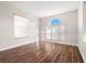 Bright and airy living room with wood floors and a large arched window at 22516 Magnolia Trace Blvd, Lutz, FL 33549