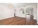 Spacious living room with dark wood floors, arched doorways, and a decorative chandelier at 22516 Magnolia Trace Blvd, Lutz, FL 33549