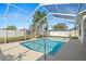Inviting screened-in pool area, perfect for relaxation and entertaining, with clear blue water under a bright sky at 22516 Magnolia Trace Blvd, Lutz, FL 33549