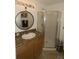 Bathroom featuring granite counters, wood cabinets, and a glass enclosed walk-in shower at 2332 Seward Dr, Sarasota, FL 34234
