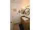 Well-lit bathroom vanity area with granite counters, round mirror, and stylish fixtures at 2332 Seward Dr, Sarasota, FL 34234