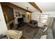 Open living room with a stone fireplace, exposed beam and lots of natural light at 2332 Seward Dr, Sarasota, FL 34234