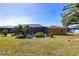 Spacious backyard with a screened pool and lush landscaping, perfect for outdoor entertaining and leisure at 2466 Lake View Blvd, Port Charlotte, FL 33948