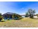 Backyard featuring a screened-in pool and ample green space, perfect for outdoor activities and relaxation at 2466 Lake View Blvd, Port Charlotte, FL 33948