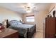 Bedroom with a comfortable bed, ceiling fan and a large window offering natural light at 2466 Lake View Blvd, Port Charlotte, FL 33948