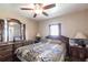 Bedroom featuring a ceiling fan, dual windows for natural light, and classic wood furnishings at 2466 Lake View Blvd, Port Charlotte, FL 33948