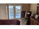 Bedroom features pool access through sliding glass doors and a television on a side table at 2466 Lake View Blvd, Port Charlotte, FL 33948