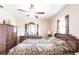 Bedroom featuring a ceiling fan, dual windows for natural light, and classic wood furnishings at 2466 Lake View Blvd, Port Charlotte, FL 33948