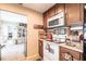 Cozy kitchen area with a microwave and a view of the living room at 2466 Lake View Blvd, Port Charlotte, FL 33948