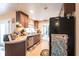 Well-lit kitchen featuring a black refrigerator and wood cabinets at 2466 Lake View Blvd, Port Charlotte, FL 33948
