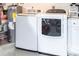 Functional laundry room with a washer, dryer, and water heater for efficient home maintenance at 2466 Lake View Blvd, Port Charlotte, FL 33948
