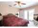 Cozy main bedroom with a comfortable bed, ample natural light, and convenient access to the outdoors at 2466 Lake View Blvd, Port Charlotte, FL 33948