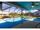Screened-in pool area featuring a pool and spa, surrounded by a well-maintained backyard at 2466 Lake View Blvd, Port Charlotte, FL 33948
