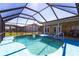This screened-in pool area features a hot tub and easy access to the home's interior at 2466 Lake View Blvd, Port Charlotte, FL 33948