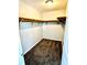 Walk-in closet provides ample storage space with wooden shelving and carpeting for organizing clothes and accessories at 2630 E 38Th Ave, Tampa, FL 33610