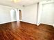 Open-concept living room with wood-look tile flooring, gray walls, and seamless flow to other areas at 2630 E 38Th Ave, Tampa, FL 33610