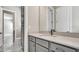 Well-lit bathroom with gray cabinets and lots of storage space at 33759 Ocean Spray Ln, Wesley Chapel, FL 33543