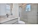 Bathroom showing a white vanity with quartz countertops and a glass enclosed shower with bright, natural light at 33759 Ocean Spray Ln, Wesley Chapel, FL 33543