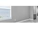 Bedroom with a large window and views of an en suite bathroom at 33759 Ocean Spray Ln, Wesley Chapel, FL 33543