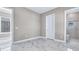 Bedroom with natural light, marble floors, and an en suite bathroom featuring a glass-enclosed shower at 33759 Ocean Spray Ln, Wesley Chapel, FL 33543