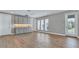 Spacious bonus room with hardwood floors, three windows, and custom gray cabinets with counter space at 33759 Ocean Spray Ln, Wesley Chapel, FL 33543