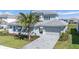 Beautiful two-story home with a paver driveway, lush landscaping, and a modern design at 33759 Ocean Spray Ln, Wesley Chapel, FL 33543