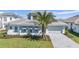 Charming single story home with tile roof, well-manicured landscaping, and paver driveway at 33759 Ocean Spray Ln, Wesley Chapel, FL 33543