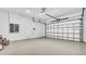 Spacious two car garage with epoxy flooring and white walls; electrical panel and garage door opener at 33759 Ocean Spray Ln, Wesley Chapel, FL 33543