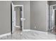 Hallway with a marble tile floor leading to various rooms in the home at 33759 Ocean Spray Ln, Wesley Chapel, FL 33543