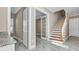 Hallway with wood stairs, marble floors and featuring a door with glass panels for office entry at 33759 Ocean Spray Ln, Wesley Chapel, FL 33543