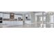 Open kitchen with white cabinets, stainless steel appliances, and an eat-in island at 33759 Ocean Spray Ln, Wesley Chapel, FL 33543