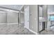 Open-concept living room featuring designer lighting and wet bar with wine fridge at 33759 Ocean Spray Ln, Wesley Chapel, FL 33543