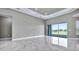 Open living area featuring marble floors, recessed lighting, and a large sliding glass door at 33759 Ocean Spray Ln, Wesley Chapel, FL 33543