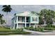 Charming coastal home featuring a two-story design, inviting porch and lush landscaping at 344A Bay St, Palm Harbor, FL 34683
