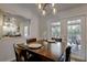 Elegant dining area with a mirrored wall and a view of the outdoor patio at 3456 Roslyn Rd, Venice, FL 34293