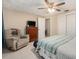 Comfortable bedroom featuring a ceiling fan, recliner, and wooden dresser at 3649 Bradford Dr, Holiday, FL 34691