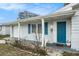 Welcoming front porch with blue door, white columns, and charming details, showcasing curb appeal at 3649 Bradford Dr, Holiday, FL 34691