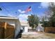 Exterior backyard view of a white home with a fenced yard and an American flag waving in the breeze at 4019 W Lemon St, Tampa, FL 33609