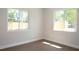 Bright bedroom featuring hardwood floors and two windows at 4019 W Lemon St, Tampa, FL 33609